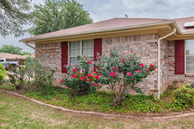 view of side of property featuring brick siding