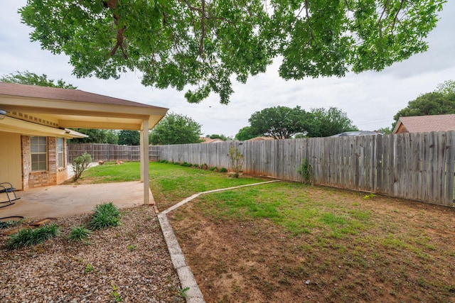 view of yard with a fenced backyard and a patio