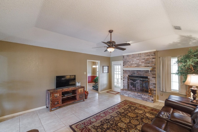 living area featuring tile patterned floors, plenty of natural light, and a fireplace