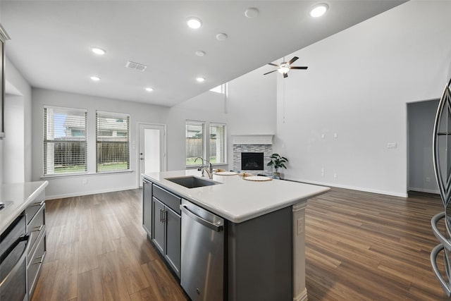 kitchen featuring a sink, dishwasher, a ceiling fan, open floor plan, and visible vents