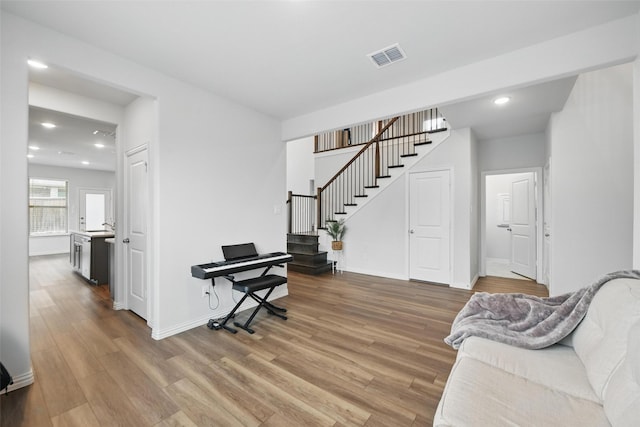 living room with stairway, baseboards, recessed lighting, and wood finished floors