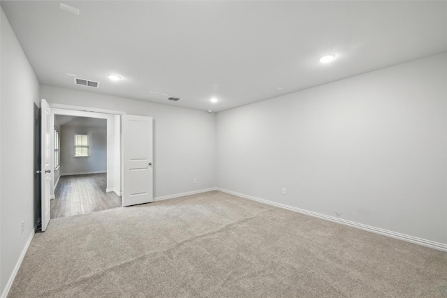 unfurnished room featuring visible vents, carpet flooring, and baseboards