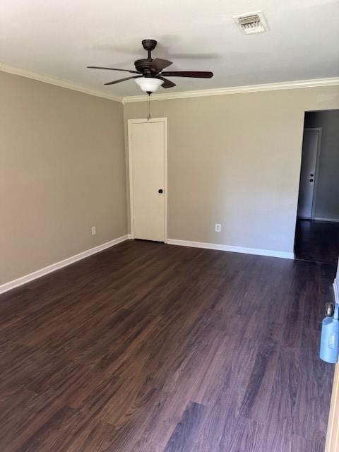empty room with baseboards, a ceiling fan, and dark wood finished floors