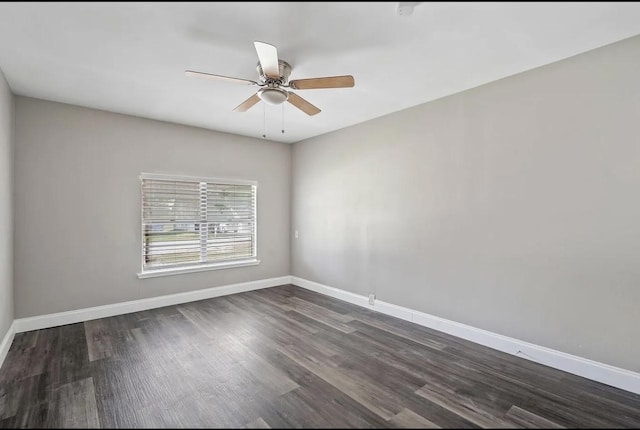 unfurnished room with baseboards, dark wood finished floors, and ceiling fan