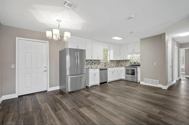 kitchen featuring white cabinetry, appliances with stainless steel finishes, an inviting chandelier, and visible vents