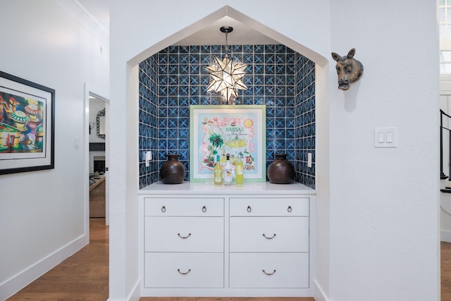 interior details with baseboards and wood finished floors