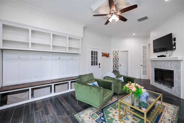 living room with wood finished floors, a ceiling fan, a tile fireplace, and visible vents