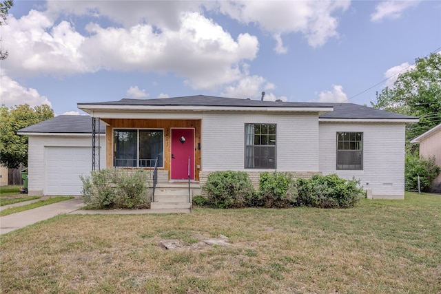 single story home with brick siding, a garage, and a front lawn
