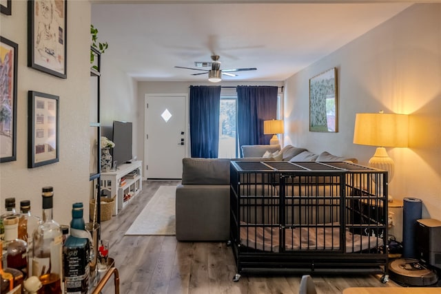 living room with ceiling fan and wood finished floors