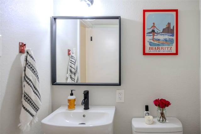 bathroom featuring toilet and a sink