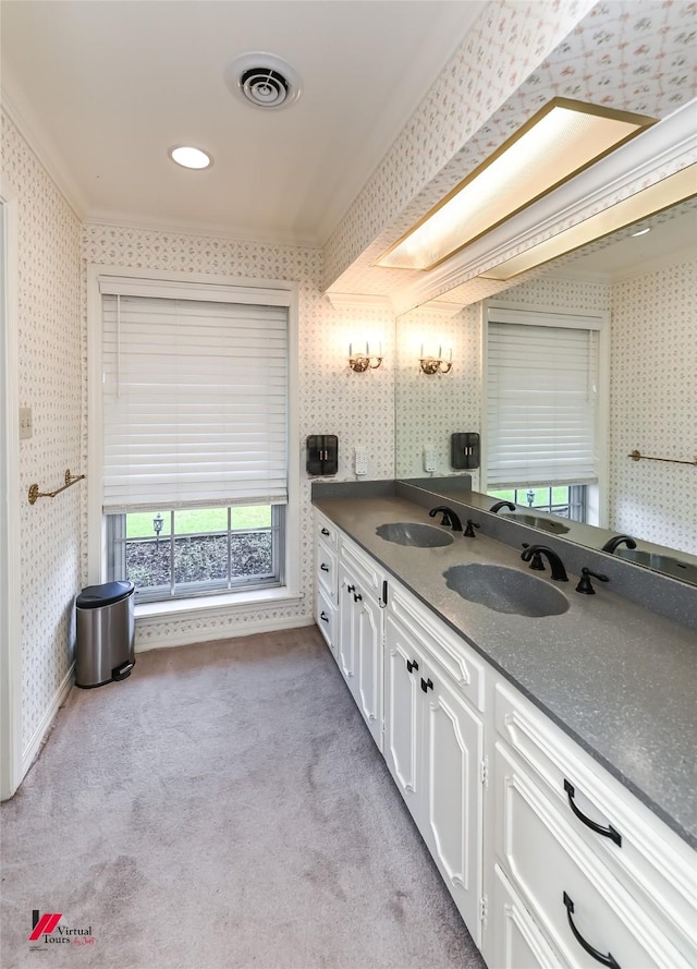 full bathroom with a sink, wallpapered walls, and visible vents