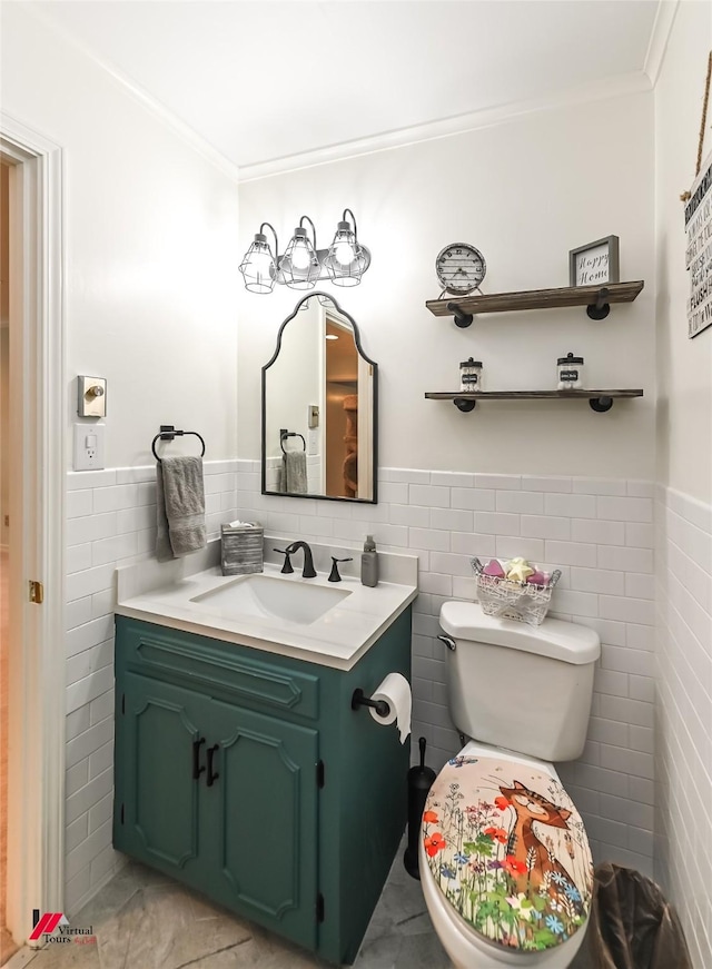 half bath with crown molding, a wainscoted wall, and tile walls