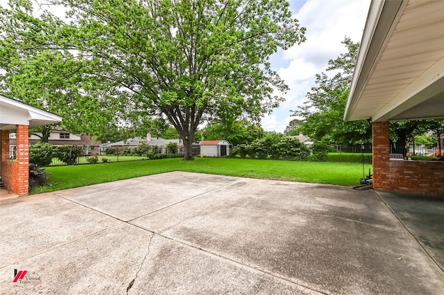 view of patio featuring a storage shed, an outbuilding, and a fenced backyard
