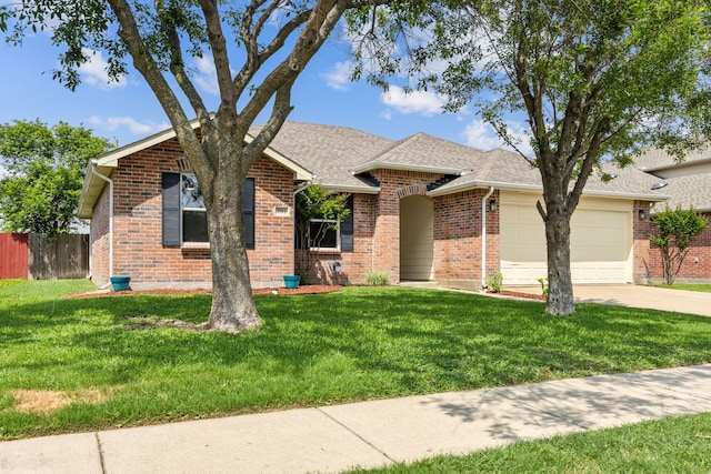 single story home with a front yard, brick siding, fence, concrete driveway, and an attached garage