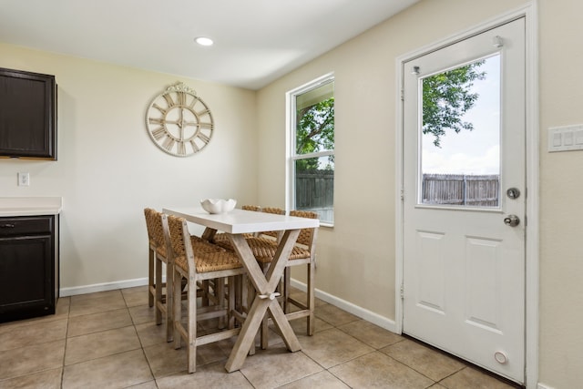 dining area with baseboards, plenty of natural light, and light tile patterned floors