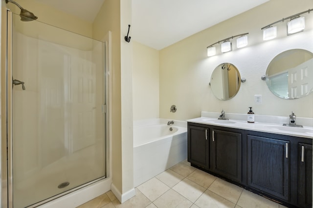 bathroom with a sink, tile patterned floors, a shower stall, and a garden tub