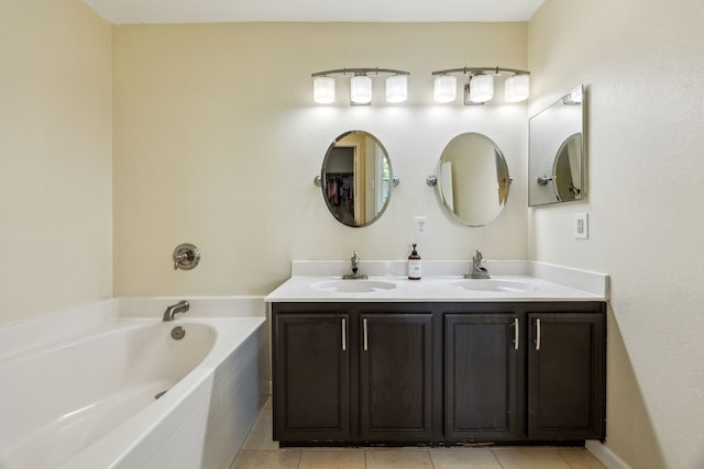 full bath featuring a garden tub, a sink, and tile patterned floors