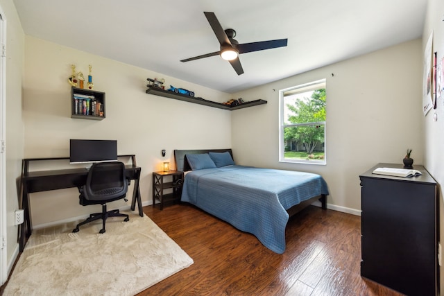 bedroom with baseboards, ceiling fan, and wood finished floors
