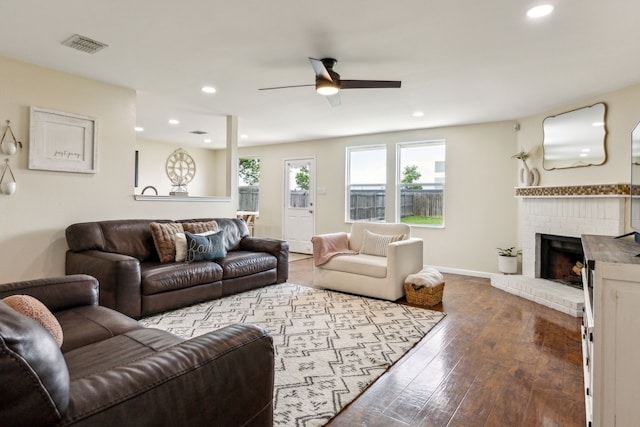 living room with a fireplace, wood-type flooring, a ceiling fan, baseboards, and recessed lighting