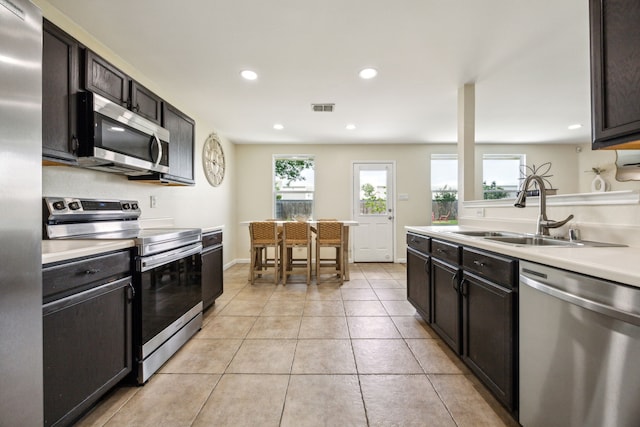 kitchen with visible vents, a sink, light countertops, stainless steel appliances, and recessed lighting
