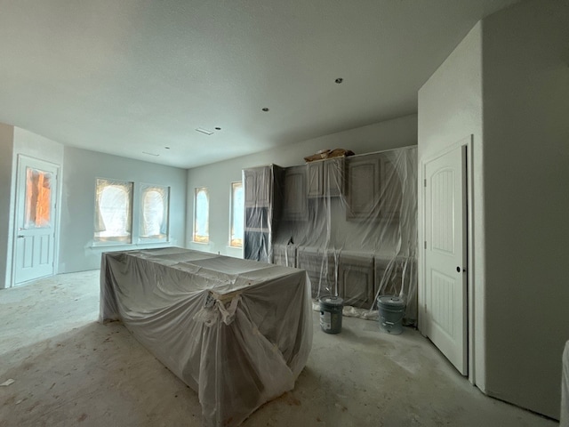miscellaneous room featuring unfinished concrete floors