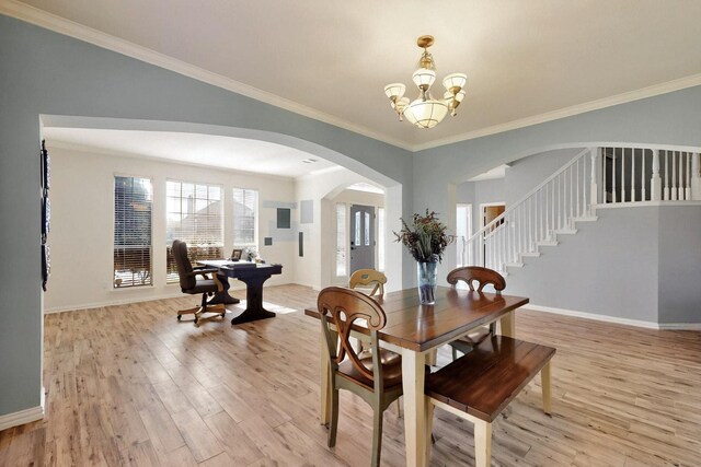 3017 Holford Rd, Richardson, TX 75082 - dining room featuring light wood finished floors, arched walkways, a chandelier, baseboards, and ornamental molding