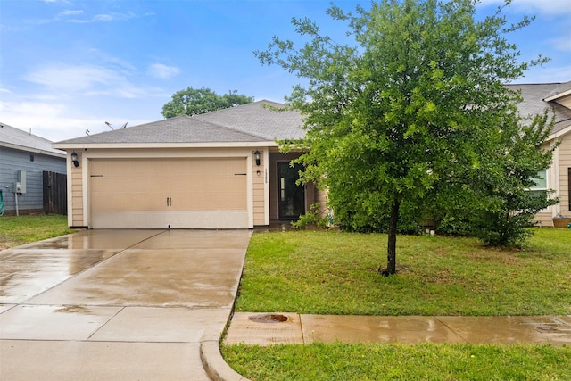 view of front facade featuring an attached garage, driveway, and a front lawn