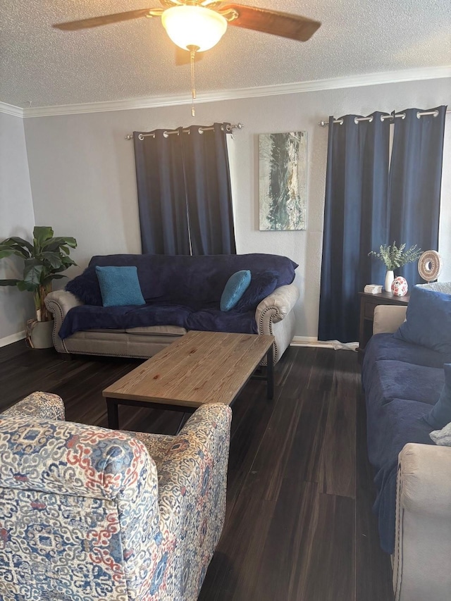 living area with a ceiling fan, a textured ceiling, wood finished floors, baseboards, and ornamental molding