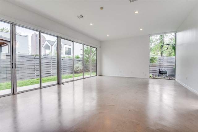 spare room with visible vents, recessed lighting, baseboards, and finished concrete floors