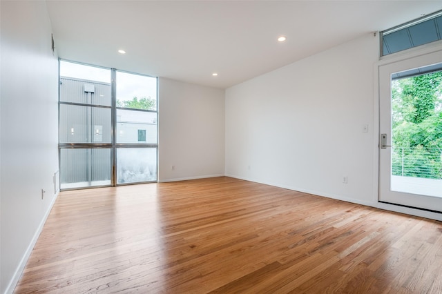 spare room featuring recessed lighting, baseboards, and light wood-style flooring