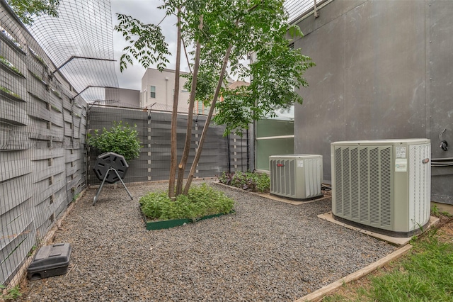 view of yard with central air condition unit and fence