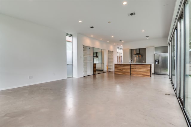 spare room featuring concrete flooring, baseboards, visible vents, and recessed lighting