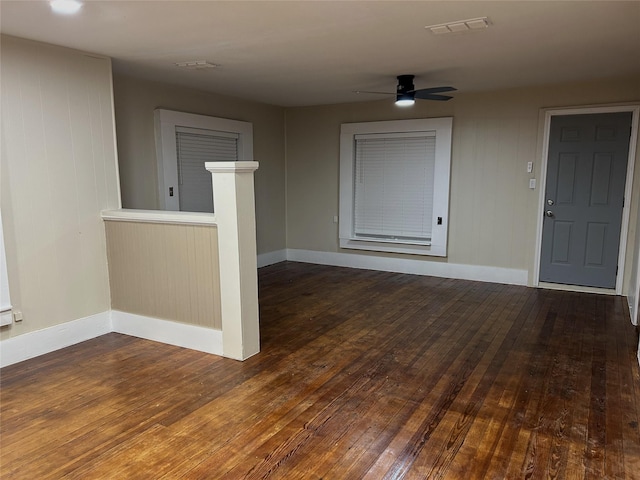 empty room with baseboards, a ceiling fan, and hardwood / wood-style flooring