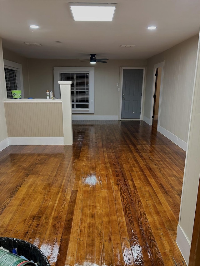 spare room with baseboards, a ceiling fan, and wood finished floors