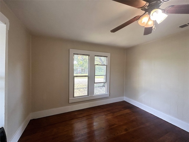 unfurnished room featuring baseboards, visible vents, ceiling fan, and dark wood-type flooring