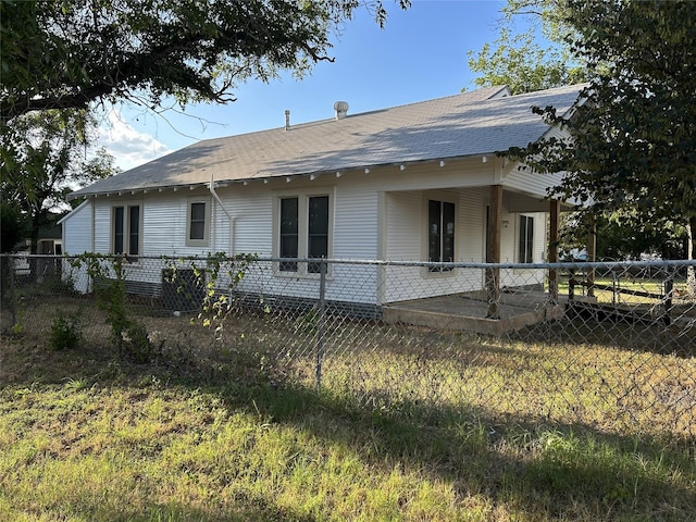 exterior space featuring a shingled roof and fence private yard