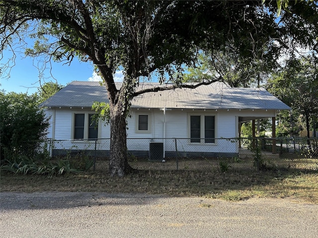 view of property exterior featuring central AC unit and fence private yard
