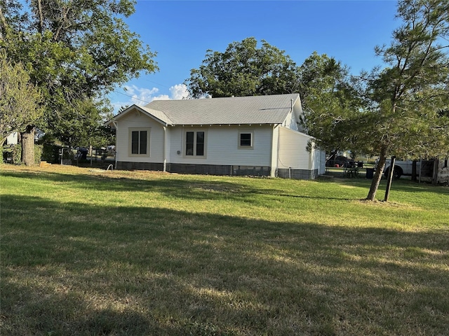 rear view of property with a yard