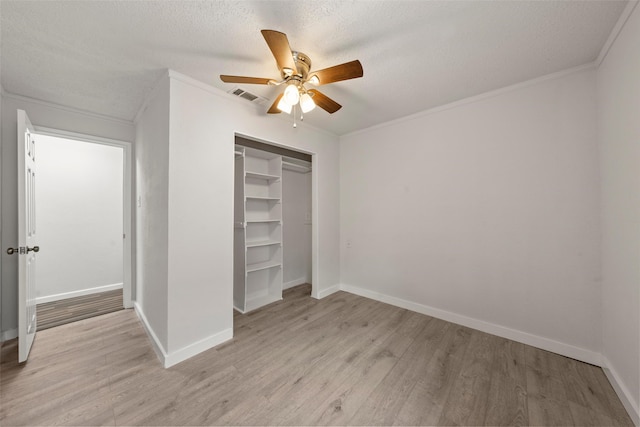 2301 Connor Ave, Waco, TX 76706 - unfurnished bedroom with a textured ceiling, visible vents, crown molding, a closet, and light wood-style floors