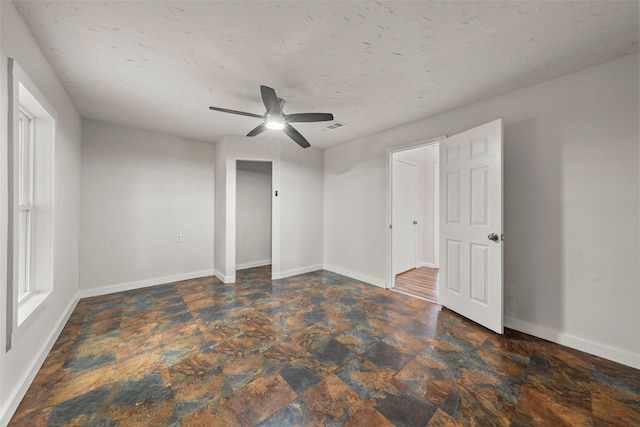 2301 Connor Ave, Waco, TX 76706 - unfurnished bedroom featuring baseboards, a ceiling fan, stone finish flooring, and visible vents