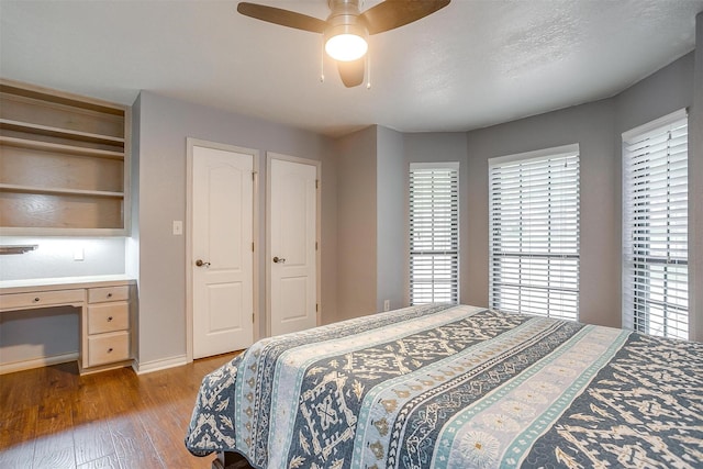 7116 Westover Dr, Granbury, TX 76049 - bedroom featuring baseboards, ceiling fan, built in desk, and wood finished floors