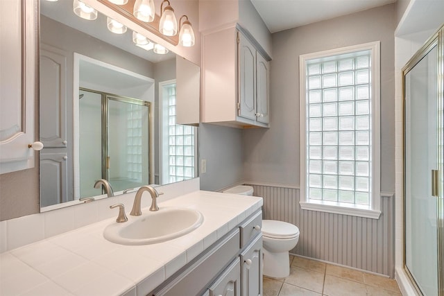 7116 Westover Dr, Granbury, TX 76049 - full bath with plenty of natural light, a wainscoted wall, toilet, and a shower stall
