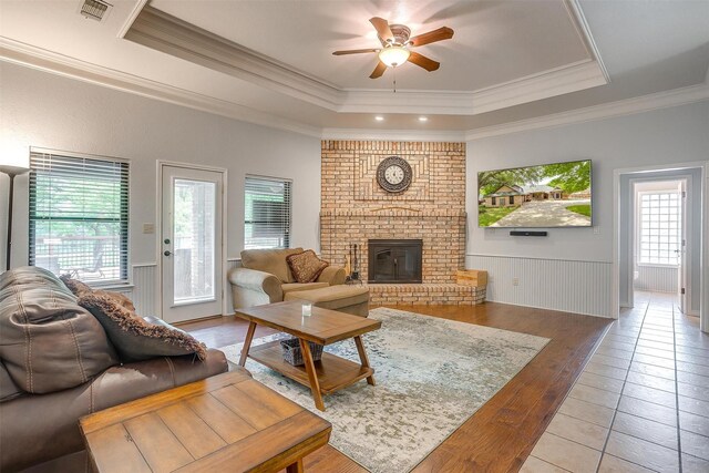 7116 Westover Dr, Granbury, TX 76049 - living area featuring a ceiling fan, a raised ceiling, light tile patterned floors, and a wealth of natural light