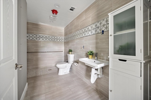 3001 Hurstview Dr, Hurst, TX 76054 - bathroom featuring toilet and tile walls
