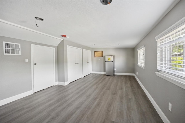 3001 Hurstview Dr, Hurst, TX 76054 - unfurnished living room featuring wood finished floors, baseboards, and a textured ceiling