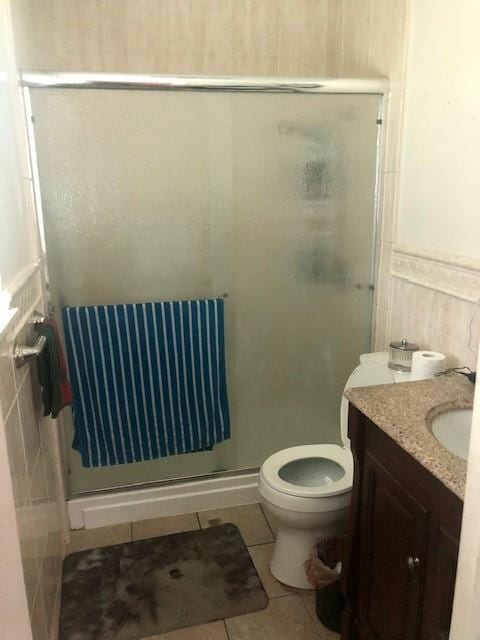 full bath featuring tile patterned flooring, radiator, and a stall shower