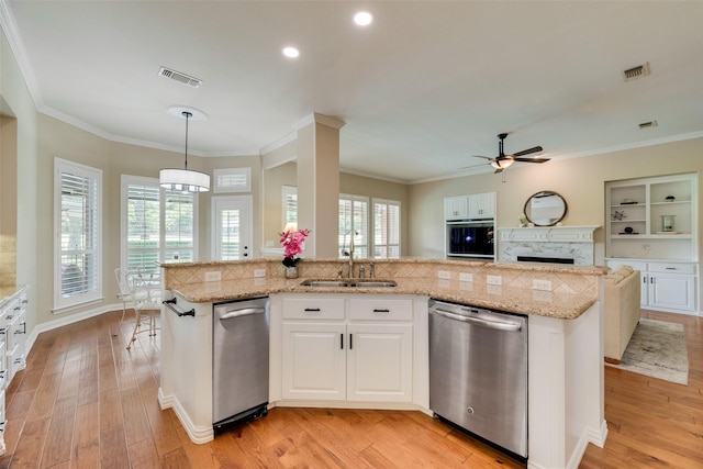kitchen with a sink, stainless steel dishwasher, a ceiling fan, and visible vents