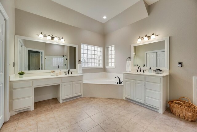 full bath with walk in shower, a sink, tile patterned flooring, two vanities, and a bath