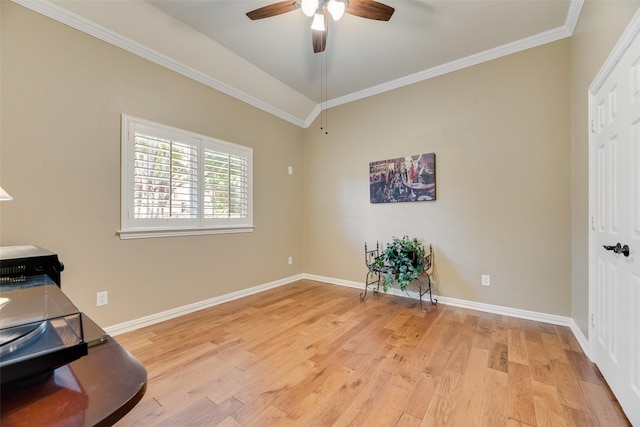 interior space with crown molding, baseboards, a ceiling fan, and light wood finished floors