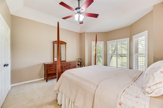 carpeted bedroom featuring baseboards and a ceiling fan